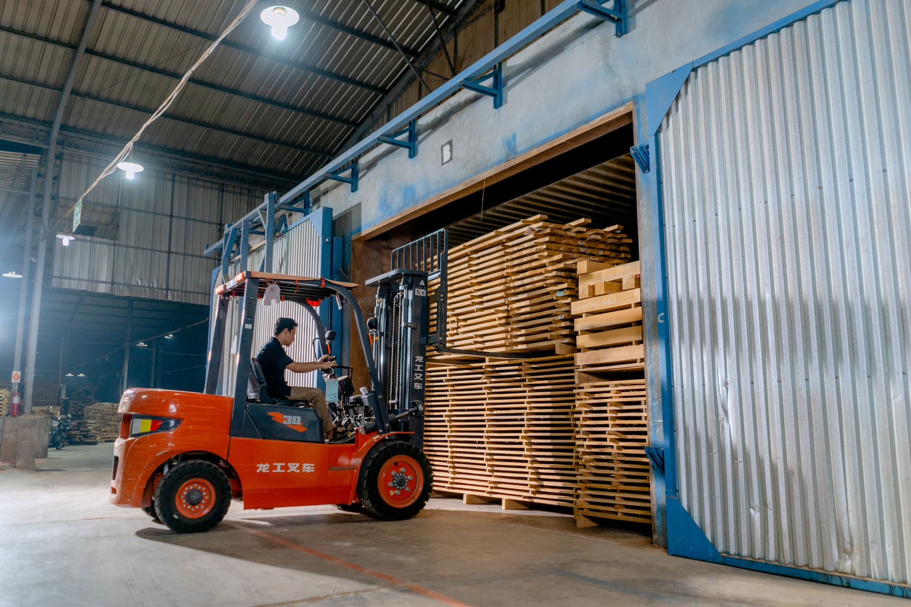 Forklift loading a container inside a warehouse